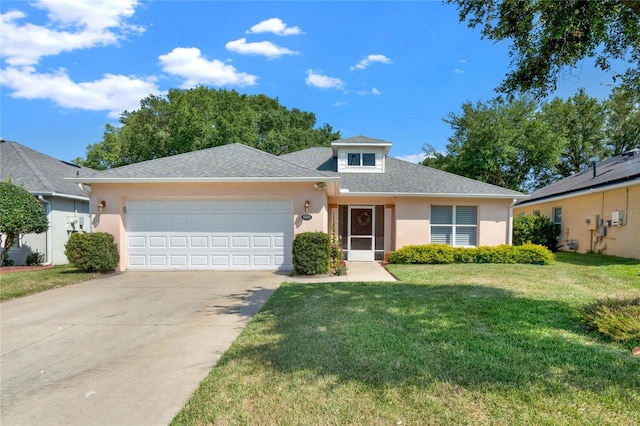 view of front facade with a garage and a front lawn