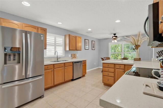 kitchen featuring ceiling fan, appliances with stainless steel finishes, sink, and plenty of natural light