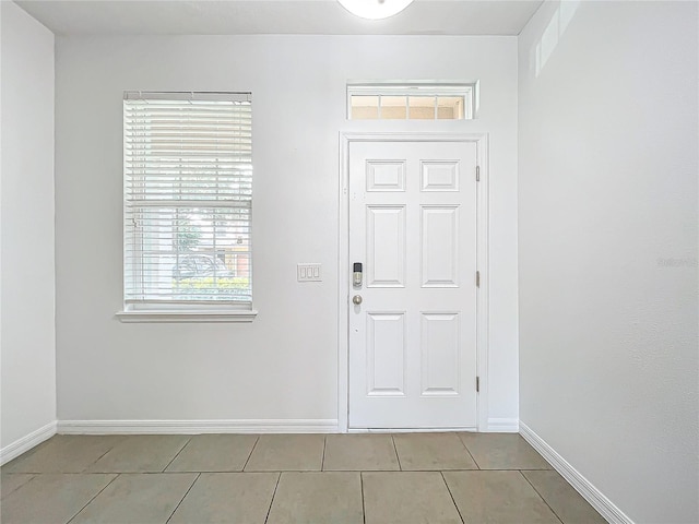 foyer entrance with light tile patterned flooring