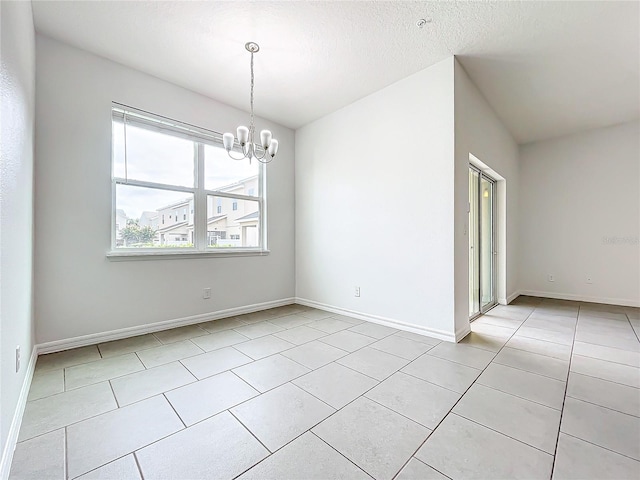 unfurnished room featuring a textured ceiling, light tile patterned floors, and an inviting chandelier