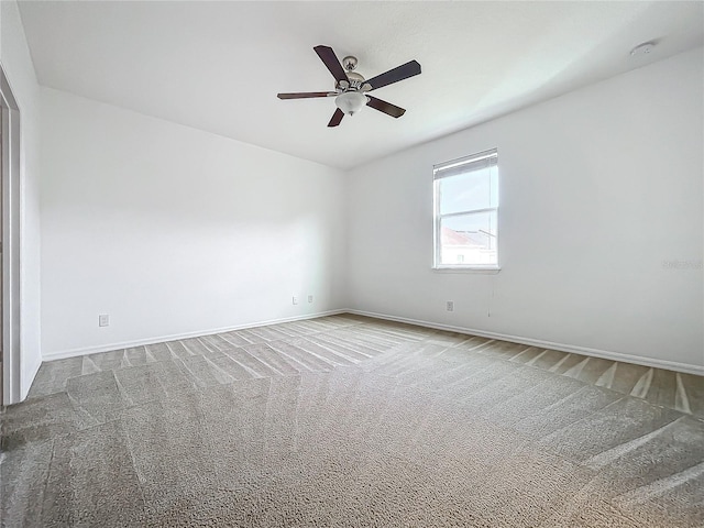 carpeted empty room with ceiling fan