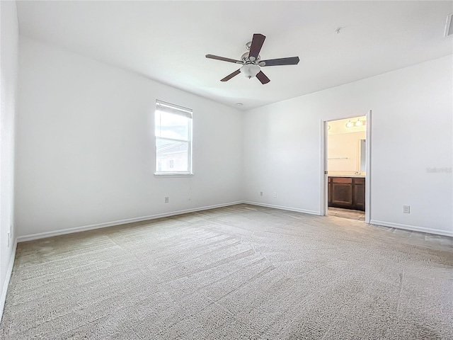 interior space with ceiling fan and light colored carpet