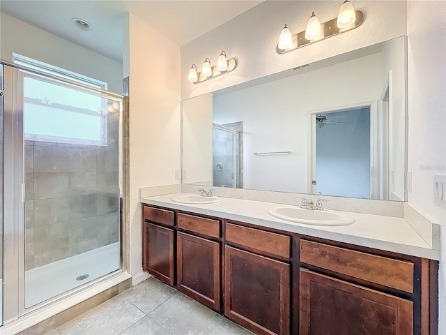 bathroom featuring dual vanity, walk in shower, and tile patterned flooring