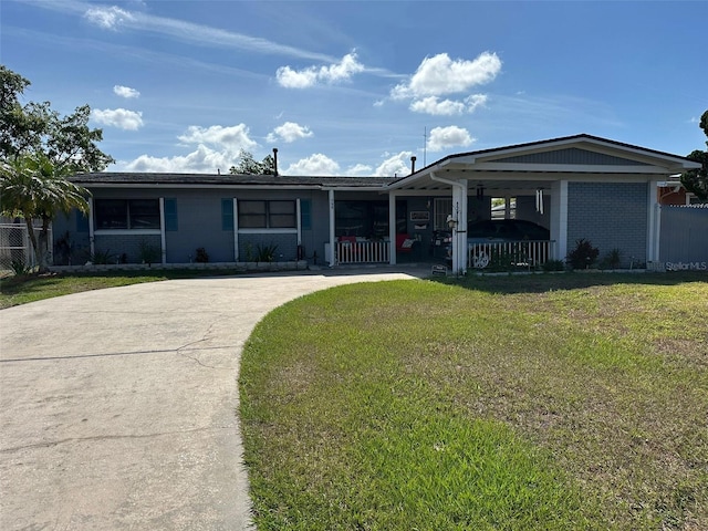 ranch-style home featuring a carport and a front lawn