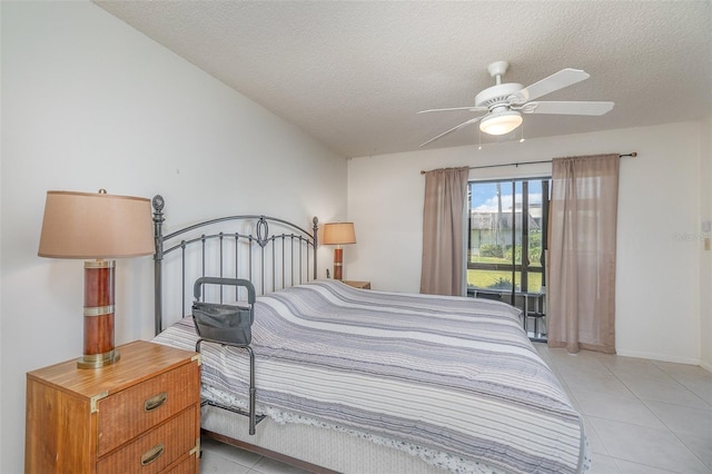 bedroom featuring ceiling fan, a textured ceiling, and light tile flooring