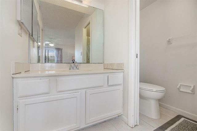 bathroom with vanity, toilet, and tile flooring