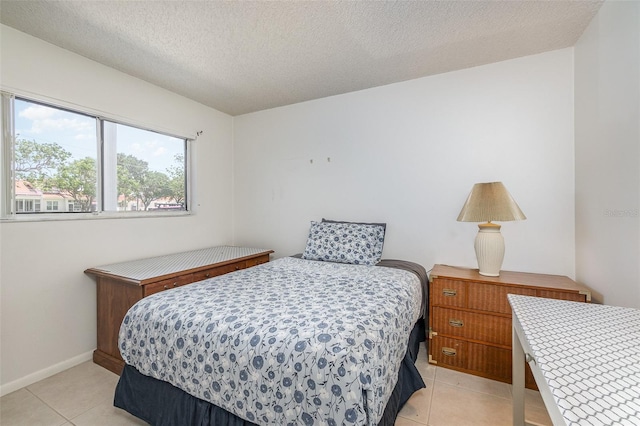 tiled bedroom with a textured ceiling