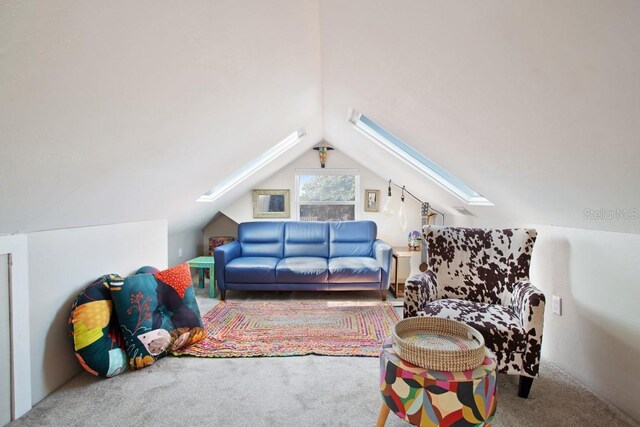 additional living space with vaulted ceiling with skylight and carpet