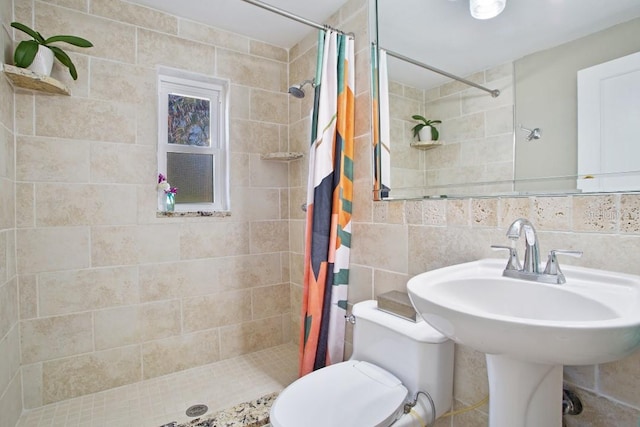 bathroom featuring decorative backsplash, toilet, tile walls, and curtained shower