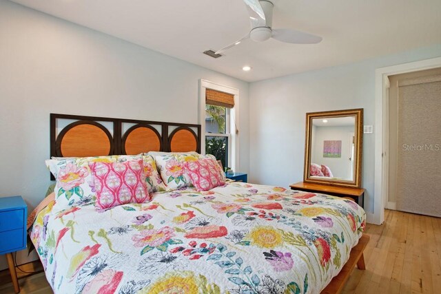 bedroom with hardwood / wood-style floors and ceiling fan