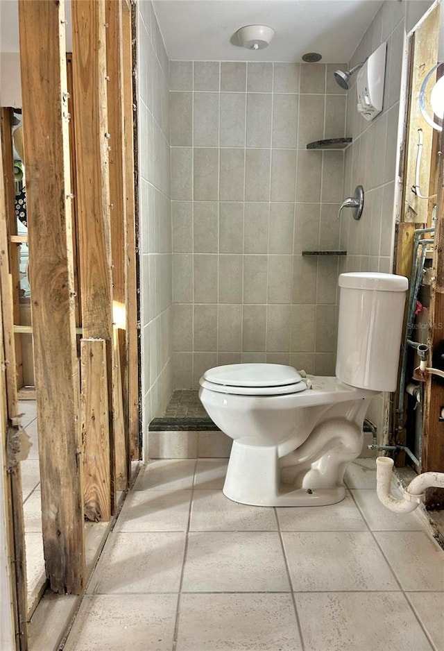 bathroom featuring toilet and tile walls