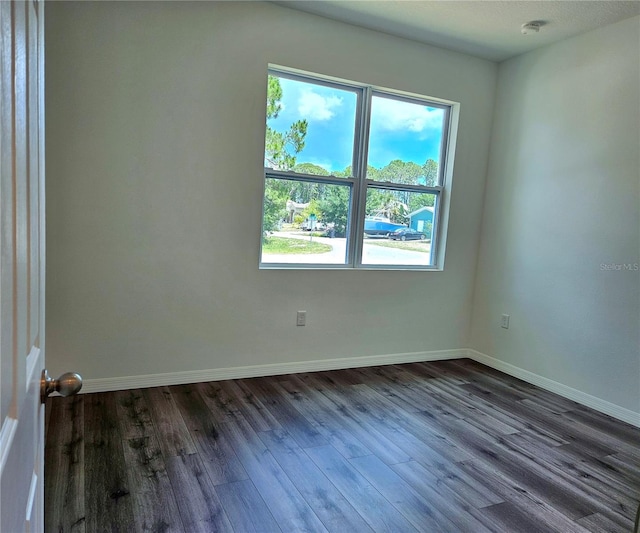 spare room featuring dark hardwood / wood-style flooring