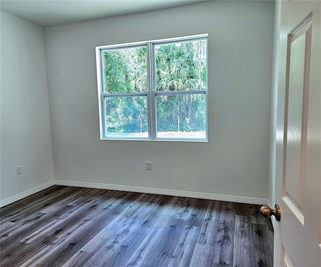 unfurnished room with dark hardwood / wood-style flooring