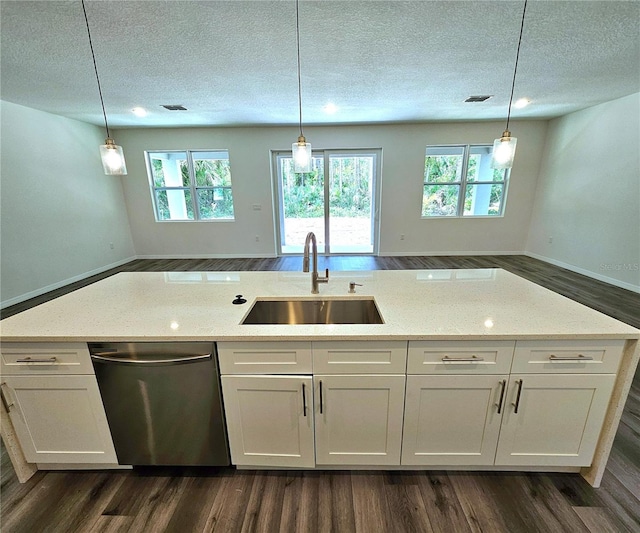 kitchen featuring stainless steel dishwasher, dark hardwood / wood-style floors, and light stone countertops