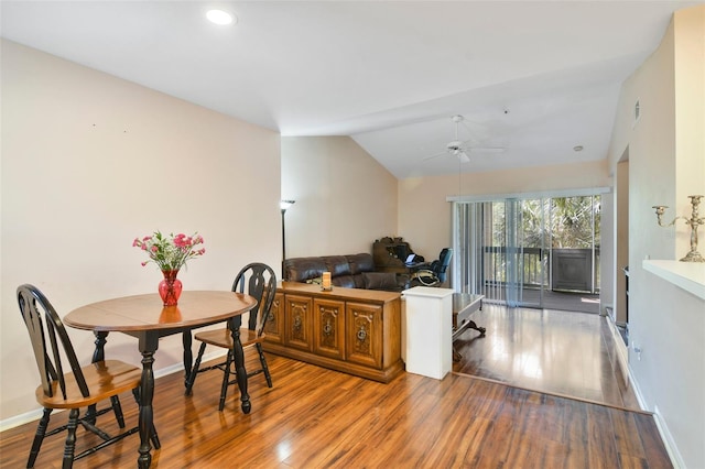 dining room featuring hardwood / wood-style flooring, vaulted ceiling, and ceiling fan