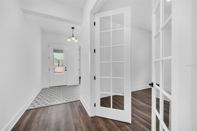 interior space with french doors, dark hardwood / wood-style flooring, and a notable chandelier