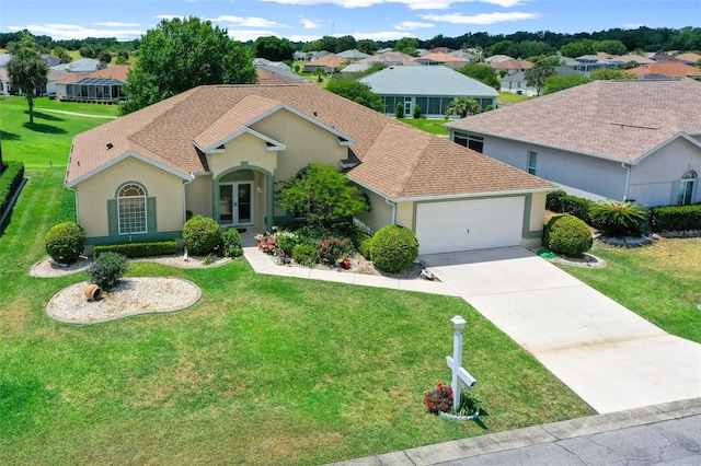 view of front of home featuring a front yard and a garage