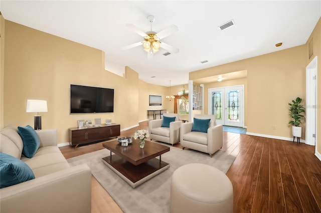 living room with hardwood / wood-style flooring, ceiling fan, and french doors