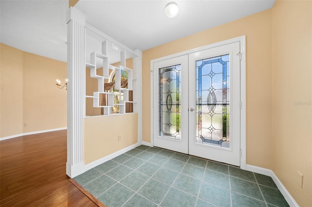 doorway featuring dark tile flooring and french doors