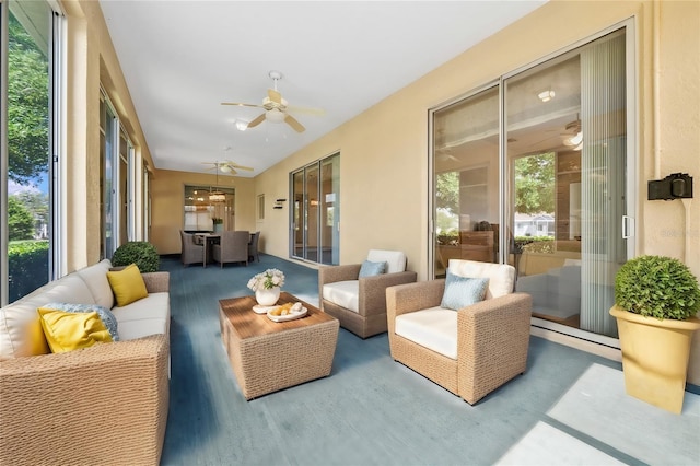 sunroom / solarium featuring ceiling fan