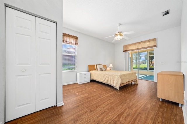 bedroom featuring access to outside, hardwood / wood-style flooring, a closet, and ceiling fan