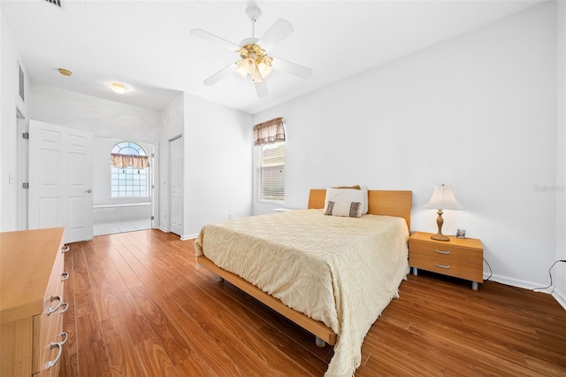 bedroom with wood-type flooring, a closet, and ceiling fan