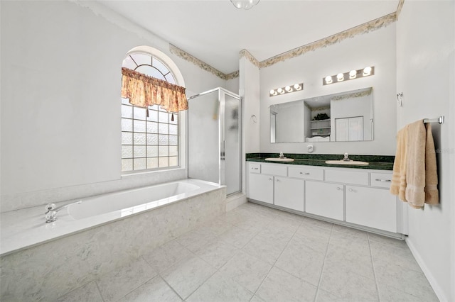 bathroom with tile flooring, separate shower and tub, dual sinks, and large vanity