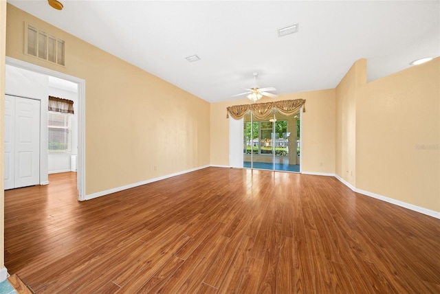 empty room with ceiling fan and wood-type flooring