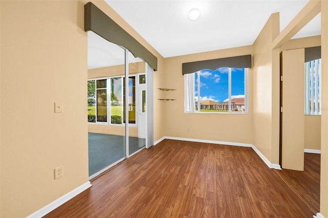 unfurnished room with wood-type flooring