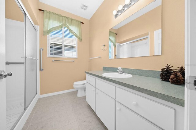 bathroom featuring a shower with shower door, toilet, tile floors, and large vanity