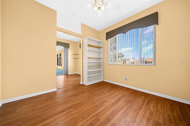 empty room featuring ceiling fan and hardwood / wood-style floors