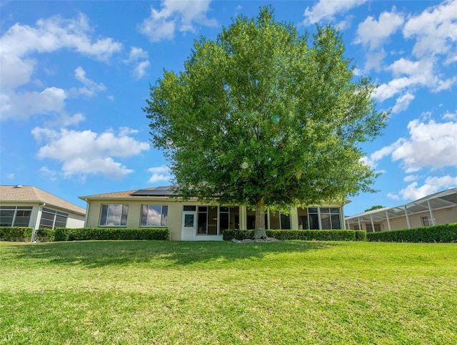 back of property featuring a lawn