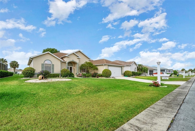 ranch-style house featuring a garage and a front lawn