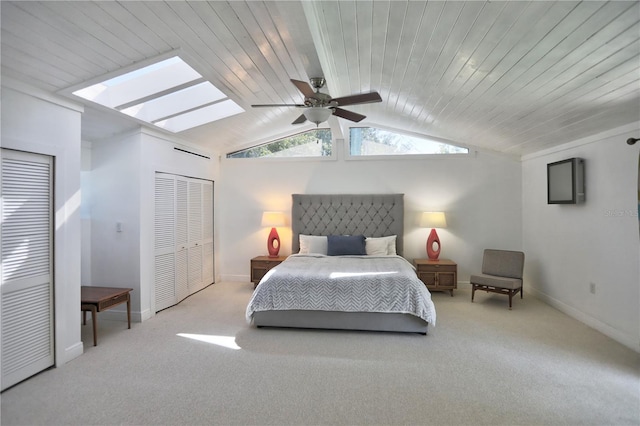 bedroom featuring light carpet, wooden ceiling, ceiling fan, and a closet