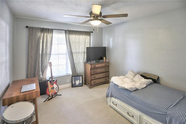 carpeted bedroom with a textured ceiling and ceiling fan