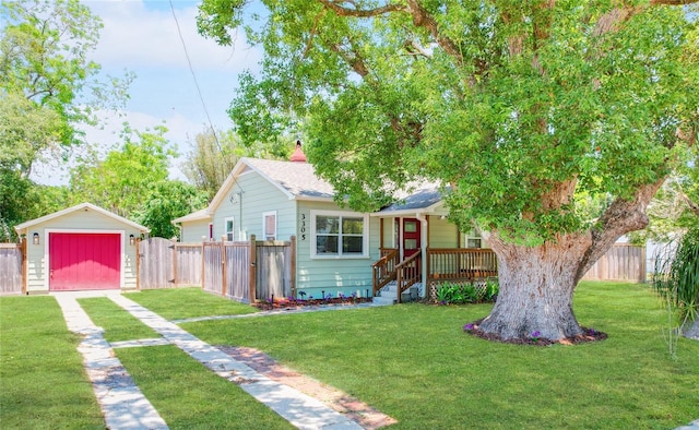 view of front of house with a garage, an outdoor structure, and a front yard