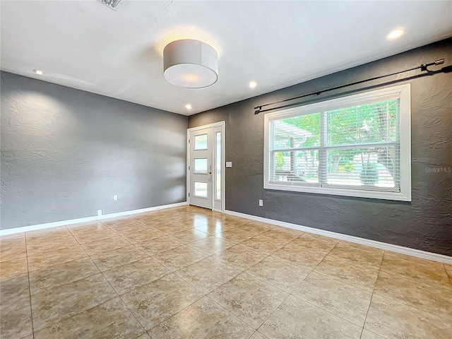 unfurnished room with light tile patterned floors