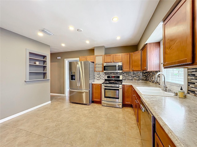 kitchen with decorative backsplash, built in shelves, stainless steel appliances, sink, and light tile patterned flooring