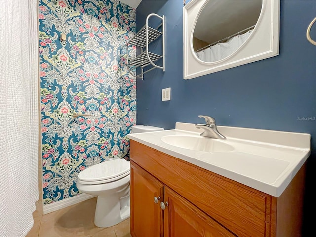 bathroom with tile patterned flooring, vanity, and toilet