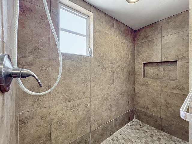 bathroom with tiled shower