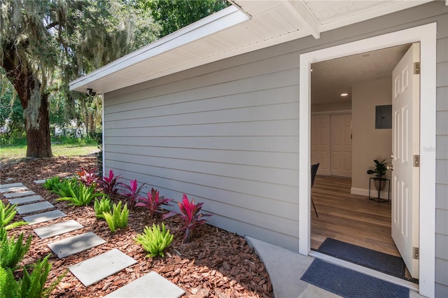 view of exterior entry with electric panel