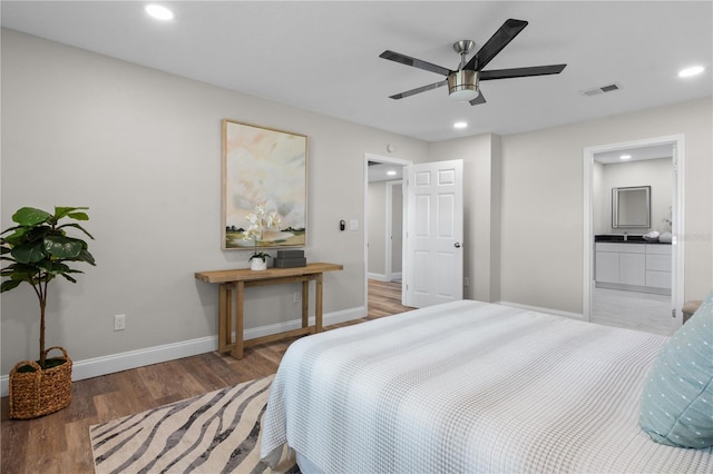 bedroom featuring recessed lighting, visible vents, light wood-style floors, ensuite bath, and baseboards