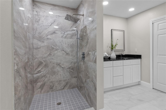 bathroom featuring marble finish floor, recessed lighting, a marble finish shower, and vanity