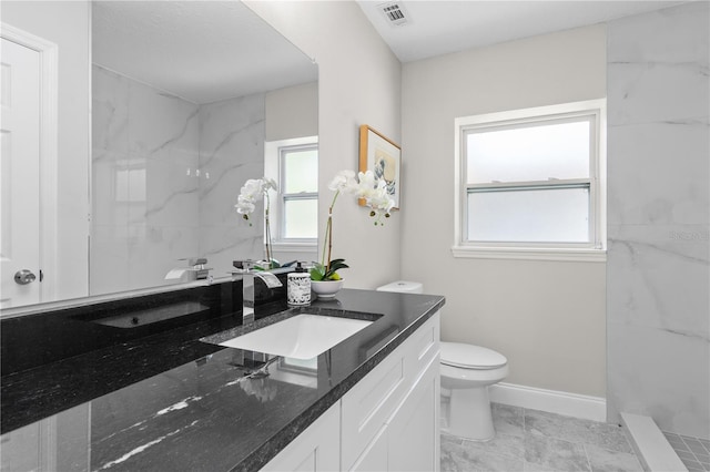 full bathroom with toilet, vanity, visible vents, baseboards, and marble finish floor