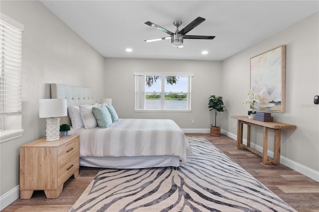 bedroom featuring ceiling fan, baseboards, wood finished floors, and recessed lighting