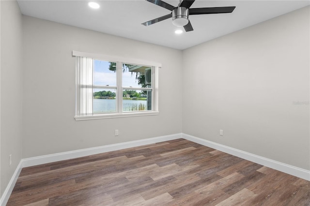 unfurnished room featuring recessed lighting, wood finished floors, a ceiling fan, and baseboards