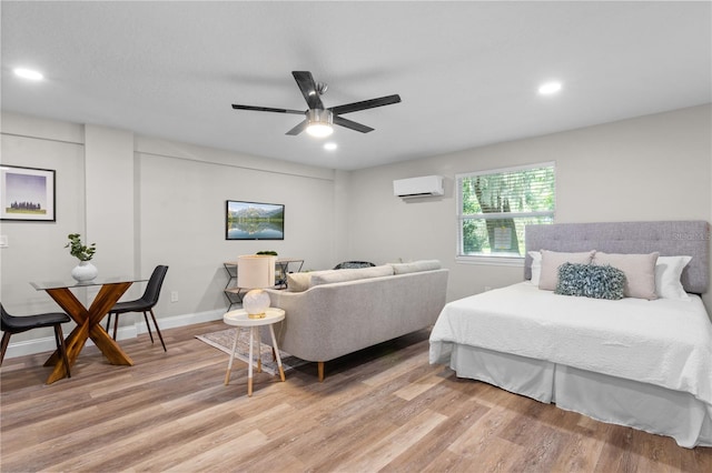 bedroom with light wood finished floors, recessed lighting, a wall mounted AC, ceiling fan, and baseboards