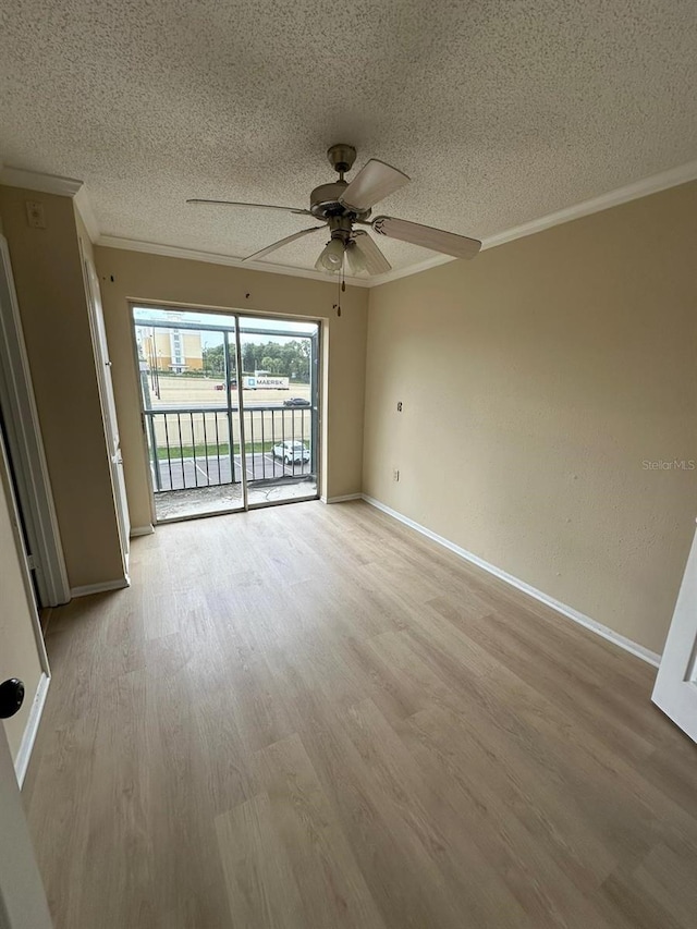 empty room with a textured ceiling, light hardwood / wood-style floors, ceiling fan, and crown molding