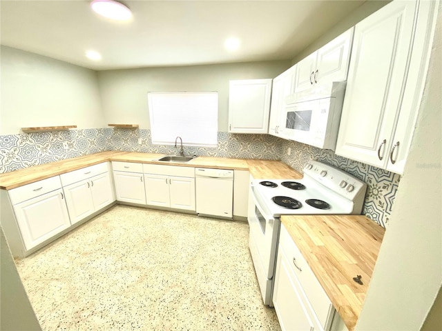 kitchen featuring sink, white appliances, wood counters, and tasteful backsplash