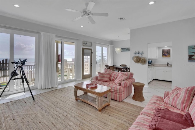 tiled living room with sink and ceiling fan